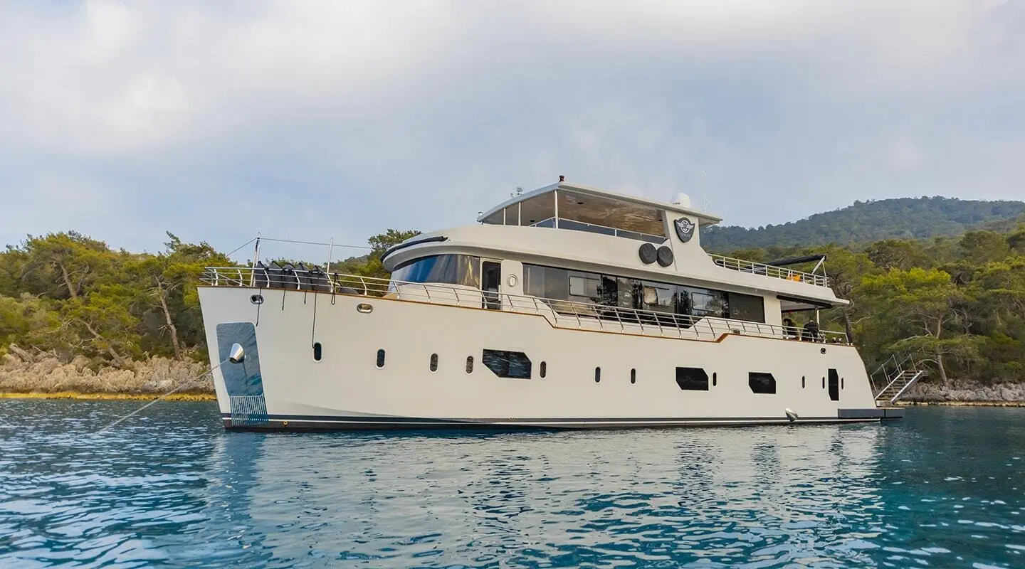 Luxury Simay M yacht anchored with white hull and multiple decks on blue water