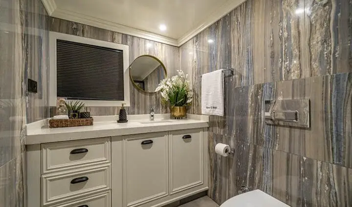 Bathroom on Queen Of Makri cabin showing vanity, sink, mirror and tiled walls