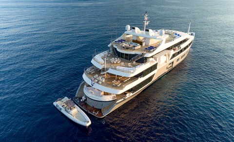 A 72m luxury motor yacht Marquise anchored on blue sea with multiple deck levels and white hull