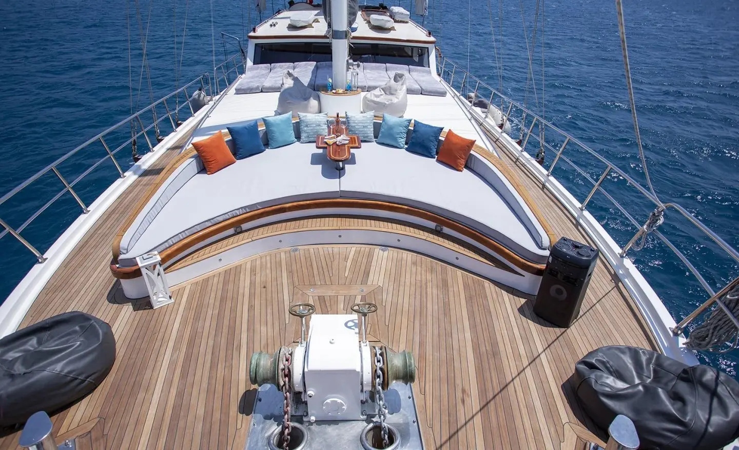Bow deck of Diva Deniz gulet with teak, ropes, and seating overlooking blue sea