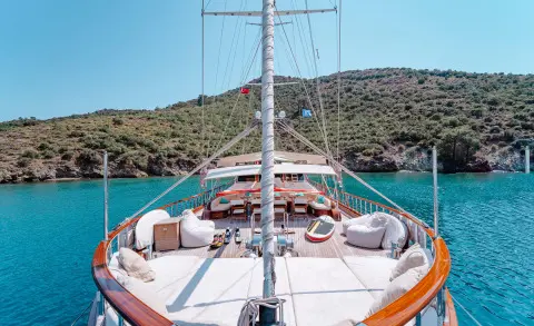 View from the bow of a wooden gulet yacht with turquoise sea surrounding