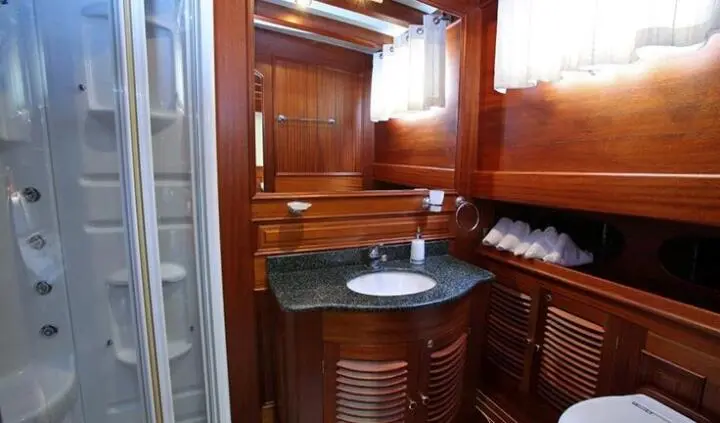 Master cabin with king bed, ensuite, wood cabinetry, porthole light