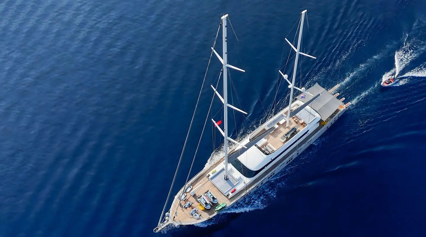 Aerial view of a luxury sailing yacht De Love anchored on calm blue sea