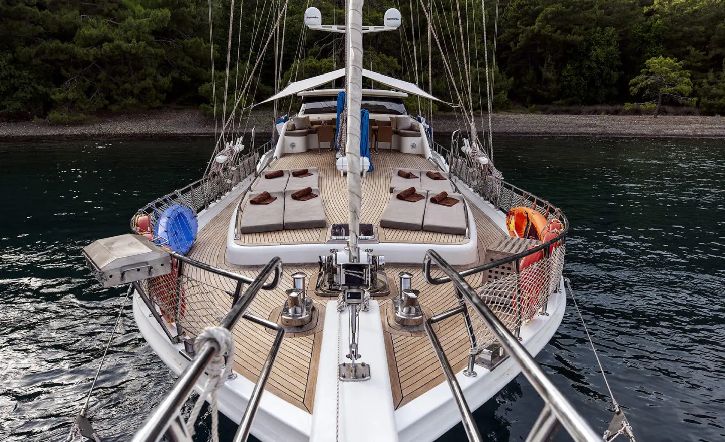 Kayhan 3 yacht deck view with lines, ropes, and shaded seating at sunset