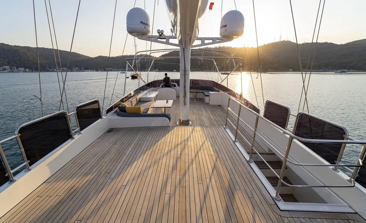 Deck of Queen Of Makri yacht at sunset with polished wooden planks