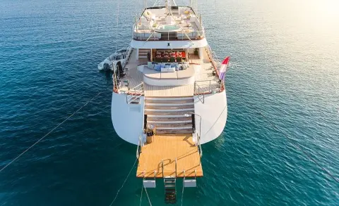 A white luxury yacht named Lady Gita sits anchored, viewed from above plan view