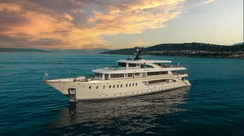 Luxurious Riva motor yacht cruising calm blue waters at sunset