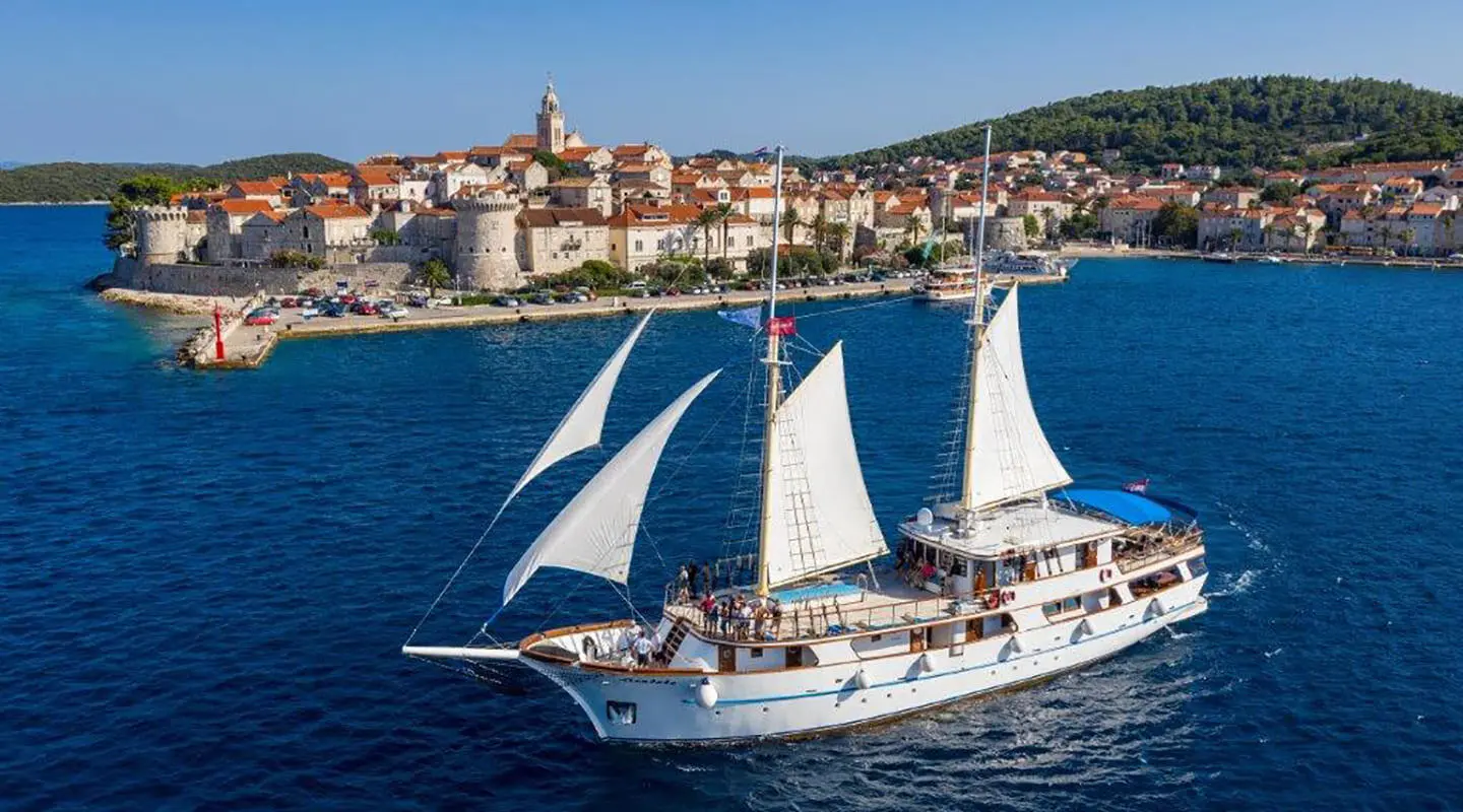 Mendula sailing gulet yacht seen on blue sea near coastline