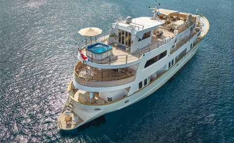 La Perla motor yacht on open water with sunbed area, pool and upper deck seating