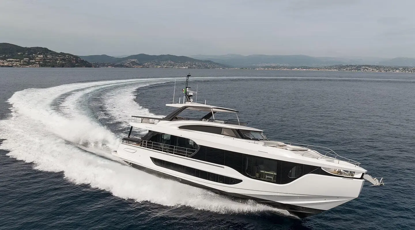 Viva II luxury motor yacht speeding on calm sea with wake trailing