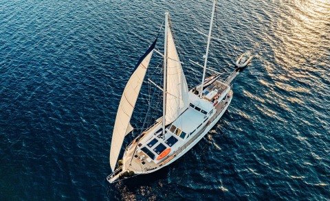 Maske yacht with large sailboat rigging seen from above on open sea