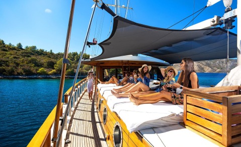 Sunlit open sea deck with sunbathing passengers on a well-appointed yacht