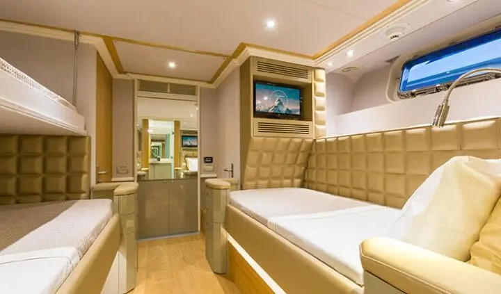 Twin-cabin ensuite aboard Aquarella: view of two beds and wood-paneled cabin