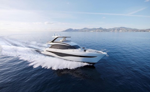 Elizabeth luxury yacht cruising on blue sea with wake behind, coastal hills in distance