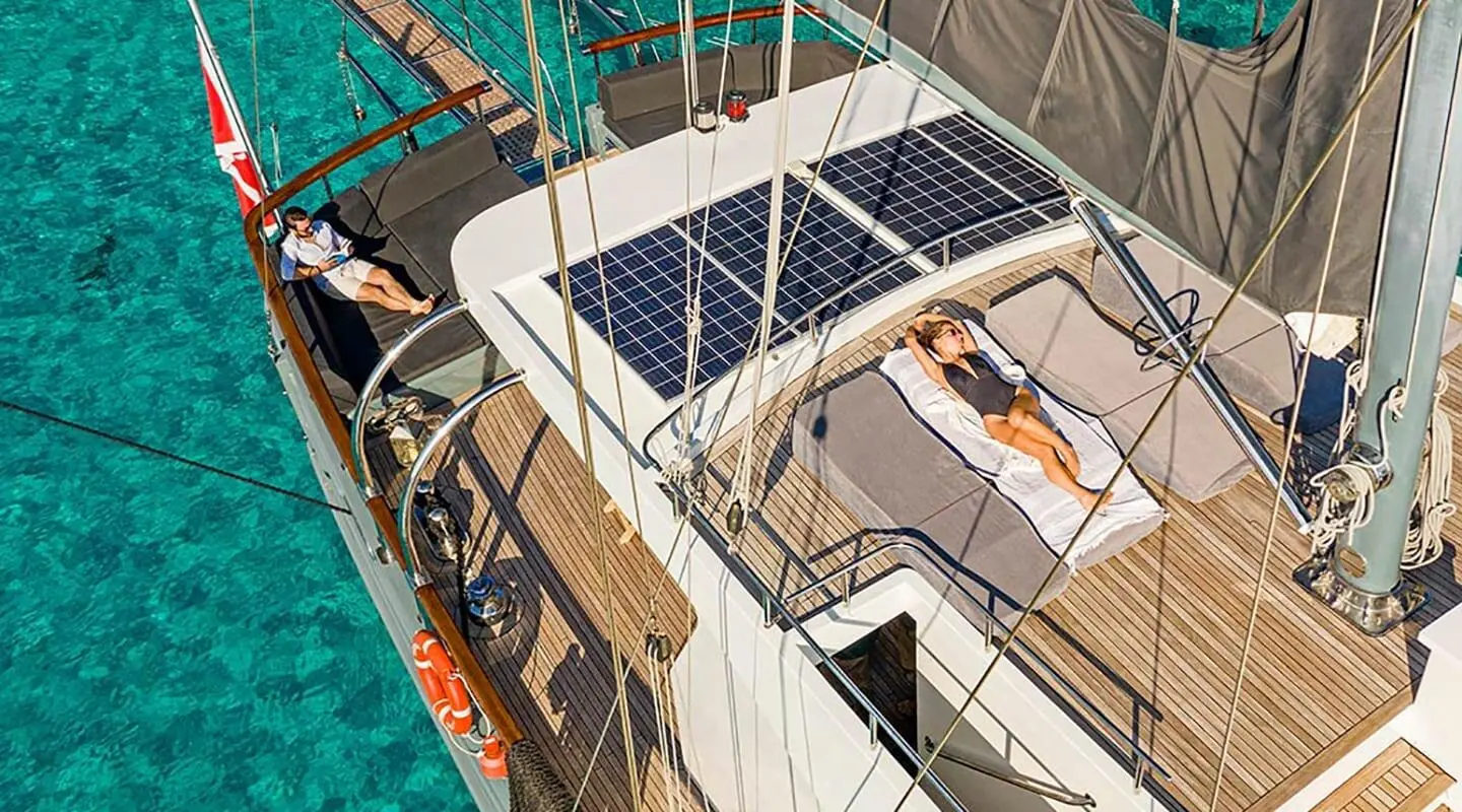Gulet Virtuoso yacht at dock with flybridge, white hull, blue water