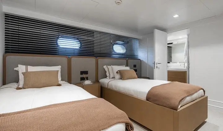 Illusion II cabin with twin beds, bunk-style layout and beige bedding