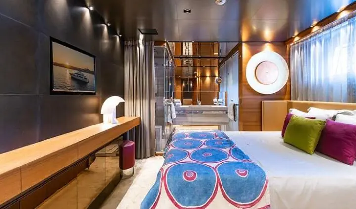 Takara One cabin with a king-size bed and navy-patterned bedding, wooden cabinetry