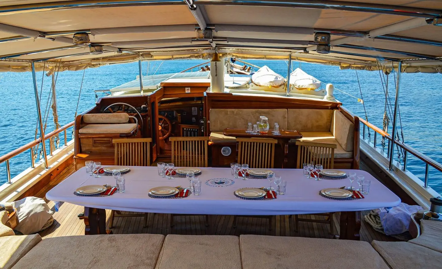 A gulet yacht Enderim A aft deck with wooden helm, seating, and ocean view