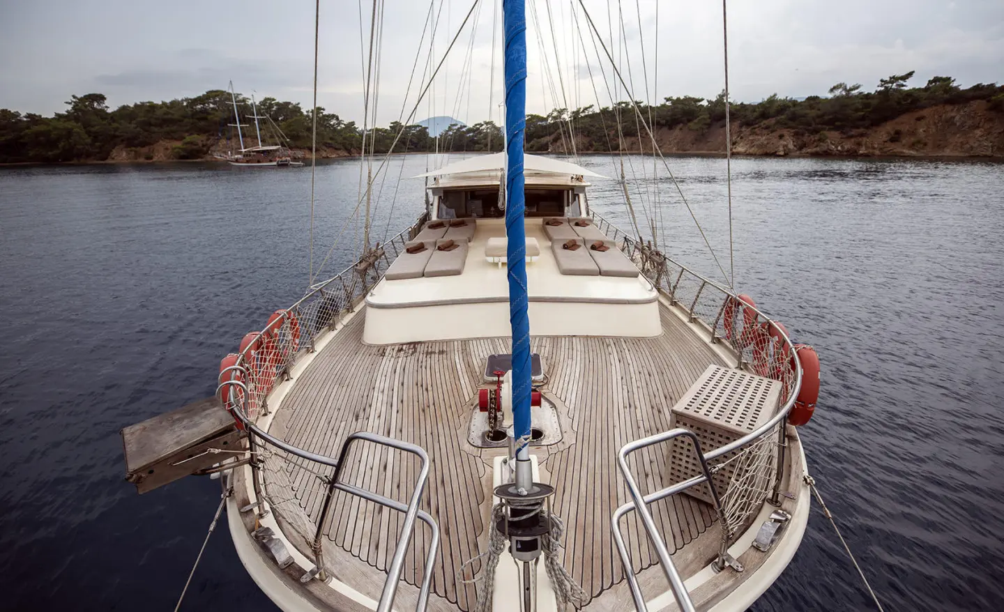 From bow deck on Faralya yacht, calm sea harbor and distant shoreline