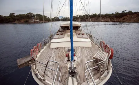 From bow deck on Faralya yacht, calm sea harbor and distant shoreline