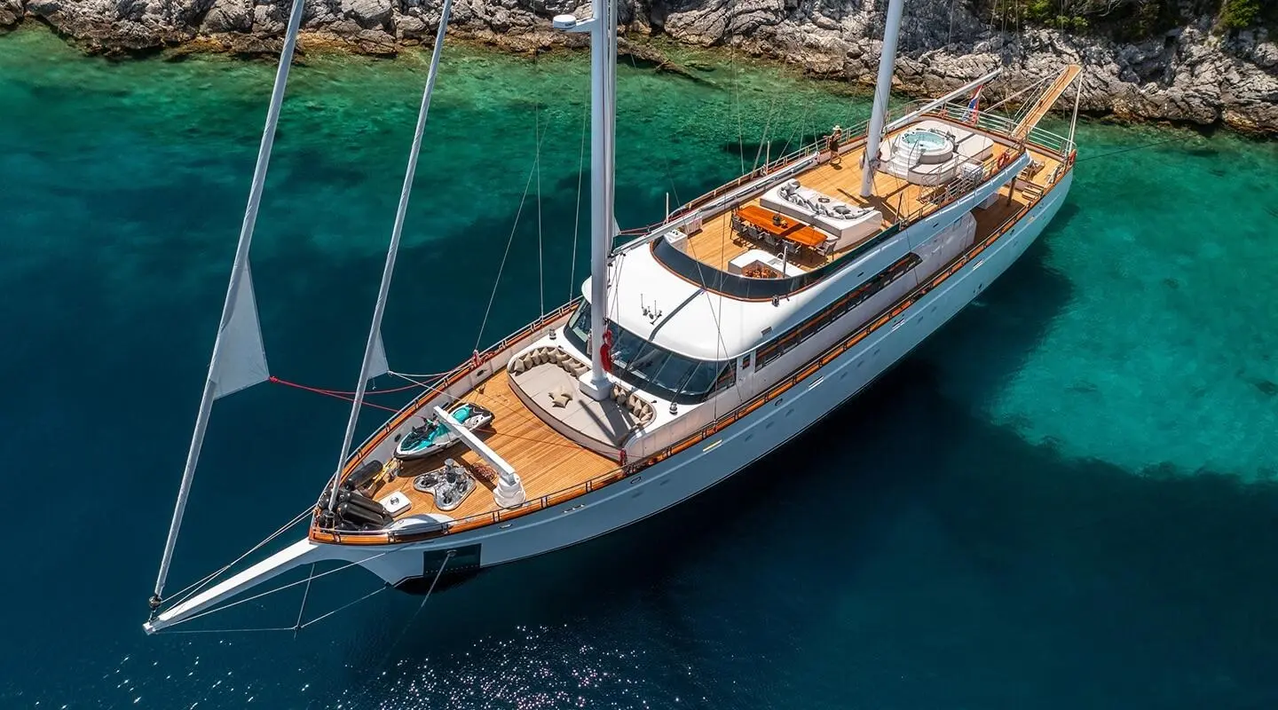 Love Story luxury gulet sailing at sunset, wooden deck, white sails, calm blue sea