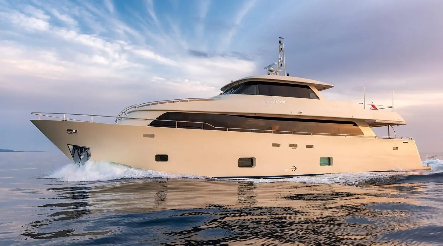 Side view of a luxurious white motor yacht Grace cruising on calm waters