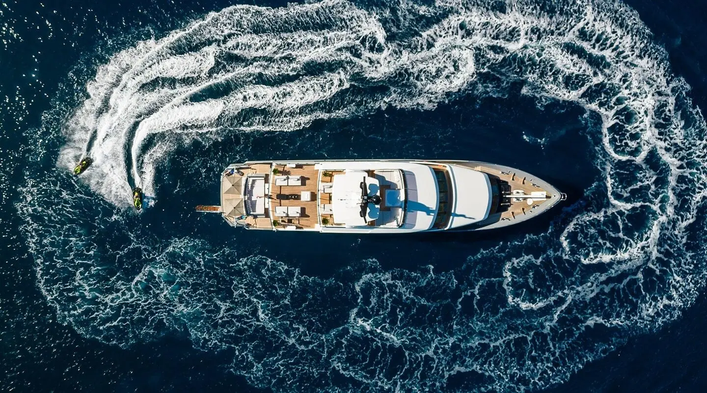 Top-down view of Illusion II luxury yacht cruising blue ocean water