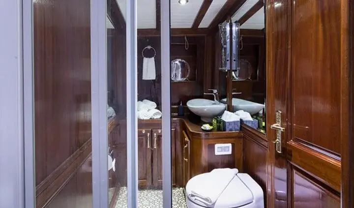 Grace 1 yacht cabin with king bed and ensuite visible through glass doors
