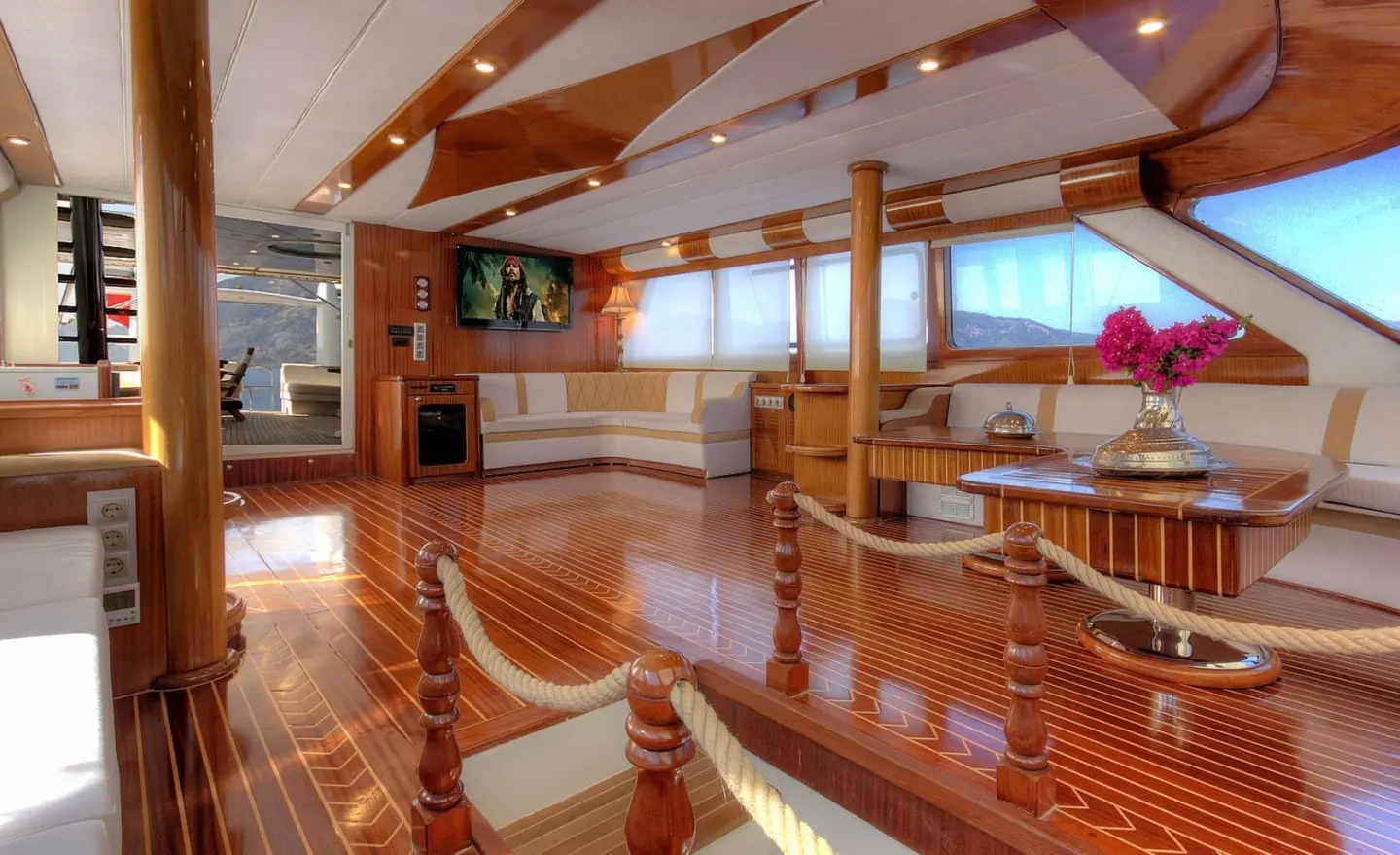 Angelo II luxury gulet deck at sunset with polished wood and seating area