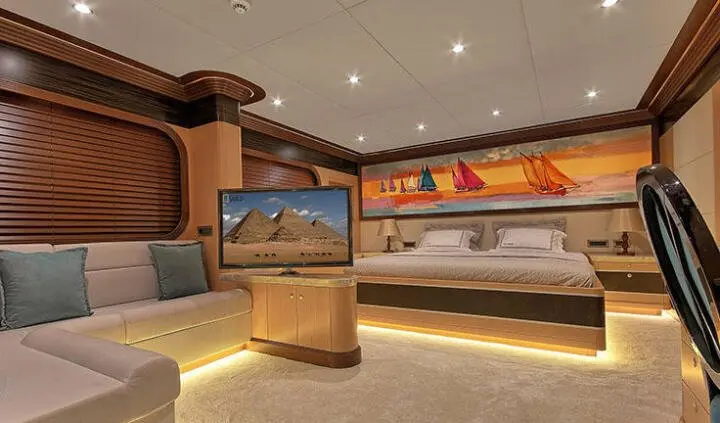 Meira yacht master cabin with king bed, ensuite visible in softly lit room