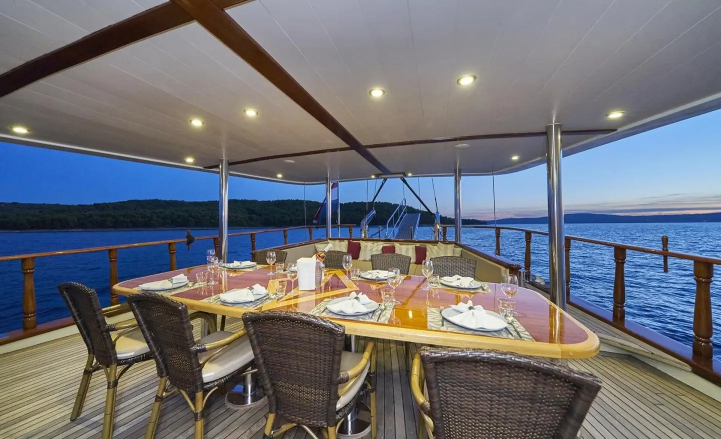 Morning Star gulet aft deck with dining setup under a wooden canopy