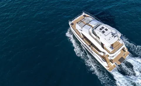 Overhead view of a luxury yacht named By My Side sailing on calm blue water at sunset