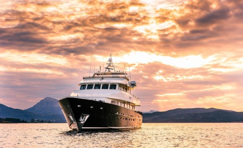 Magix luxury yacht cruising at sunset on calm waters