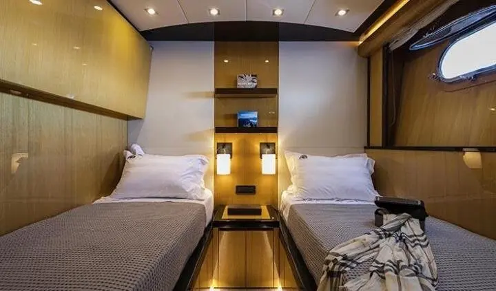 Luxurious twin cabin interior with two single beds and a central walkway