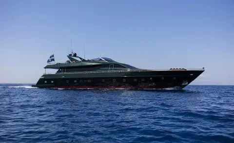 Long luxury yacht named Can't Remember anchored on calm blue sea at sunset