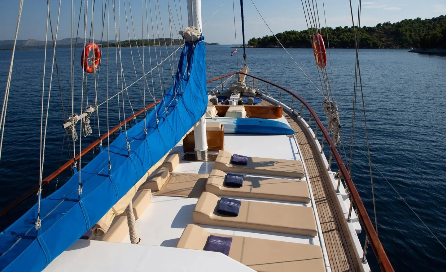 Sunset-lit luxury gulet yacht Malena deck with seating and calm water