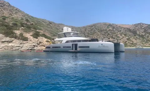 Just Marie 2 motor yacht anchored near rocky coastline with blue water