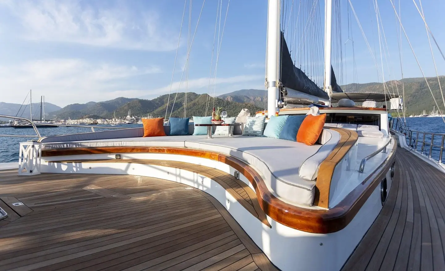 Luxury gulet Diva Deniz on deck with curved seating and colorful cushions