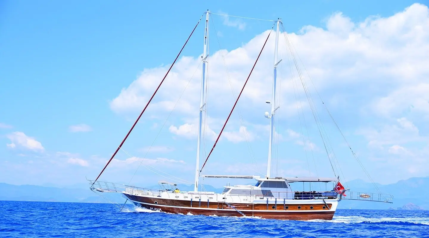 Maya sailing yacht with wooden hull and masts on blue sea