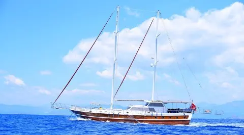 Maya sailing yacht with wooden hull and masts on blue sea
