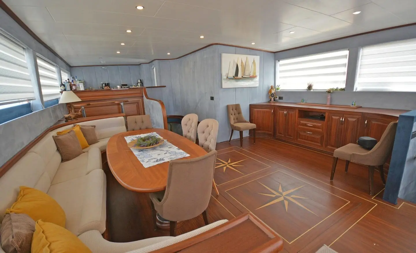 Interior view of Bella Mare luxury gulet salon with wooden decking and seating