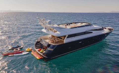 Zoi yacht anchored in open sea with dining area on aft deck