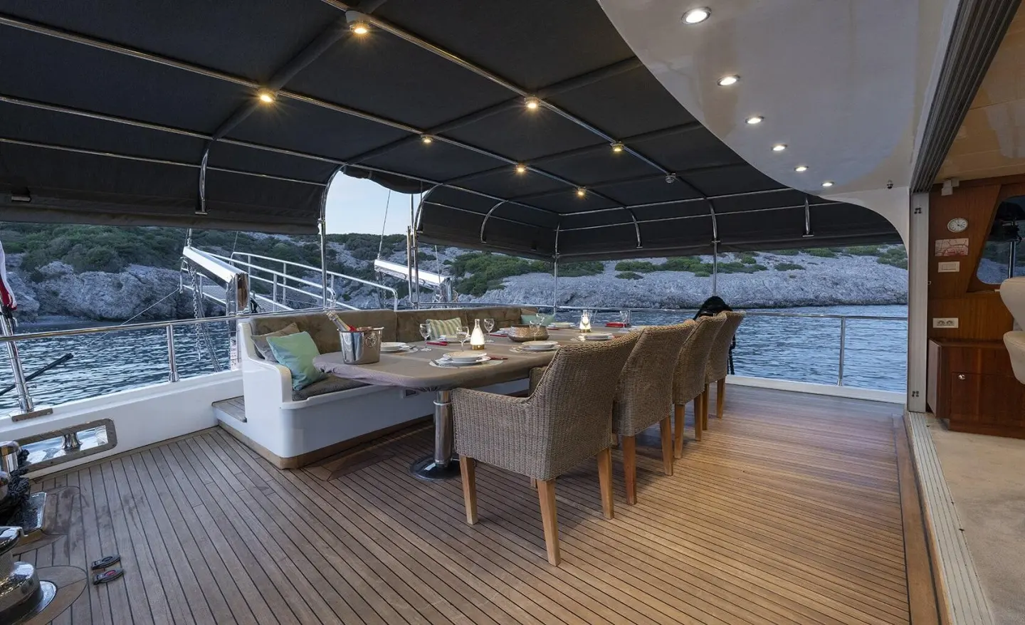 Luxurious yacht Lucky You deck at sunset with seating area under stars