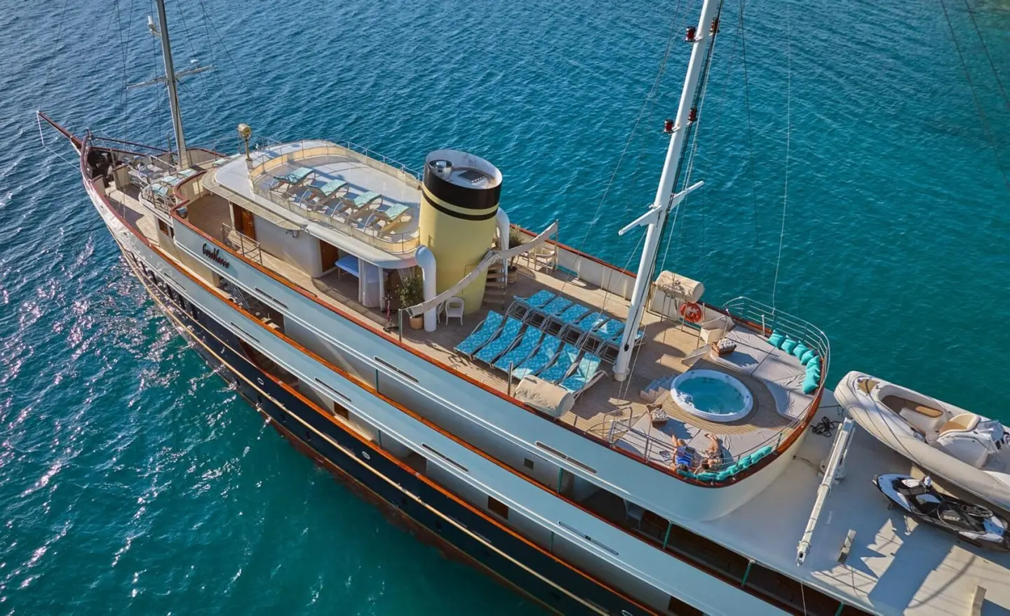 Top-down view of Casablanca luxury yacht deck with sun loungers and jacuzzi