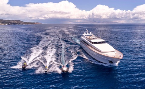 Luxurious motor yacht Mobius sailing in open sea with a white hull and upper deck