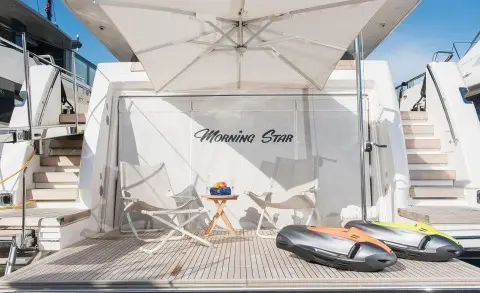 Morning Star yacht stern swim platform with deck chairs and a lifebuoy