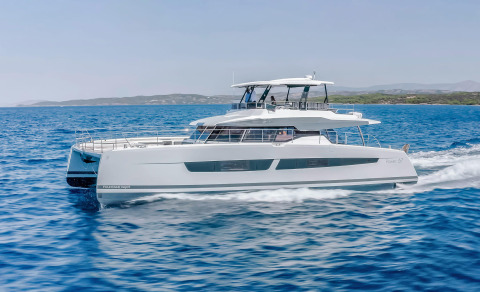 White luxury yacht cruising on blue sea with upper deck and cabin windows