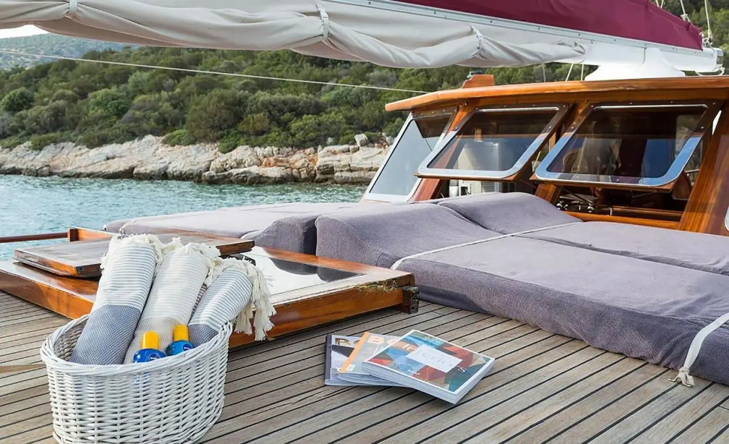 Primadonna gulet sun deck with cushioned seating and wicker basket