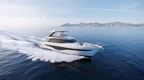 Yacht Elizabeth cruising on blue sea, wake behind, distant mountains visible