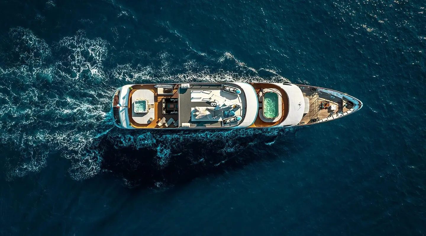 Aerial view of a luxury yacht named Freedom cruising blue ocean